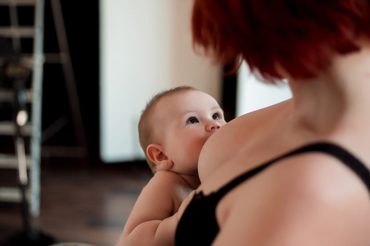 33854318 a young mother is breastfeeding her little child and looking at him tenderly